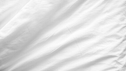 Obraz premium White wrinkled bed sheet surface. Soft fabric backdrop. Sleep and relaxation concept.