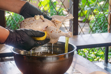 soaking whole chicken in salt water , herb and aromatic solution, for enhancing the flavor of the chicken