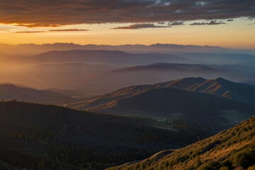 A wide, panoramic view of a mountain range at sunrise.