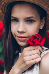 Outdoor portrait of young brunette beauty girl in rosses field	
