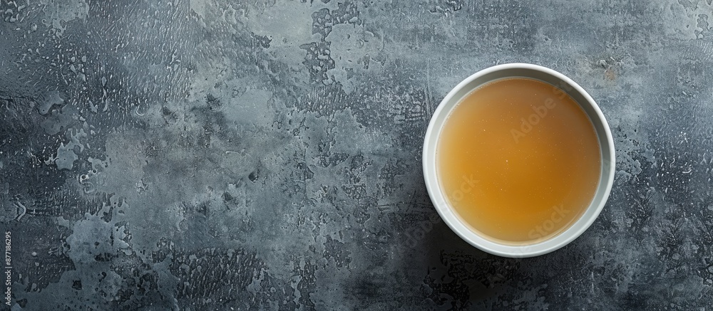 Poster A nutritious bowl of broth on a gray surface with a top down perspective offering a wide horizontal copy space image for a banner design