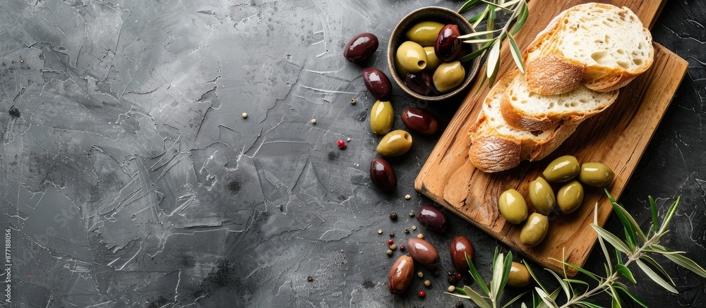 Poster top view of a cutting board with mediterranean olives and bread offering copy space for an image in 
