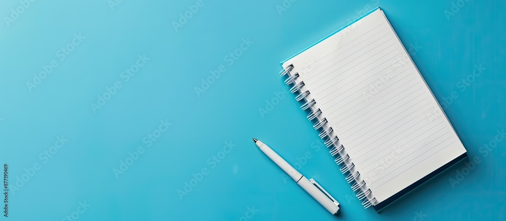 Poster Workspace mockup on blue background with notebook pen featuring copy space image