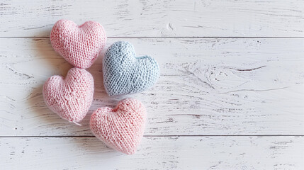 Pretty knitted yarn hearts pink blue pastel knitting crafting handmade wool romantic soft DIY love Valentine Day hobby creative crafts flatlay above pattern woolen blank banner wood background copy