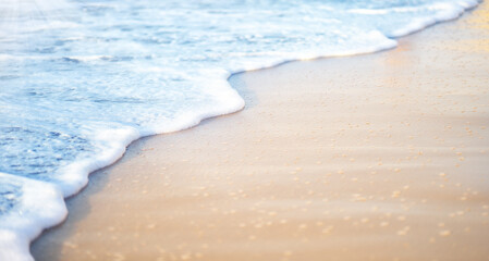 Soft wave of sea on sandy beach. Ocean Waves on Sand Beach selective focus. Summer background