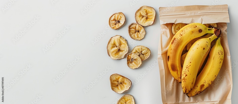 Poster Banana and dried slices in a bag with ample copy space on a white backdrop