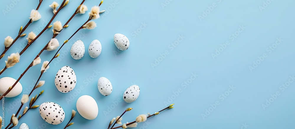 Poster Top view of a blue background with willow branch and decorative Easter eggs perfect for a copy space image