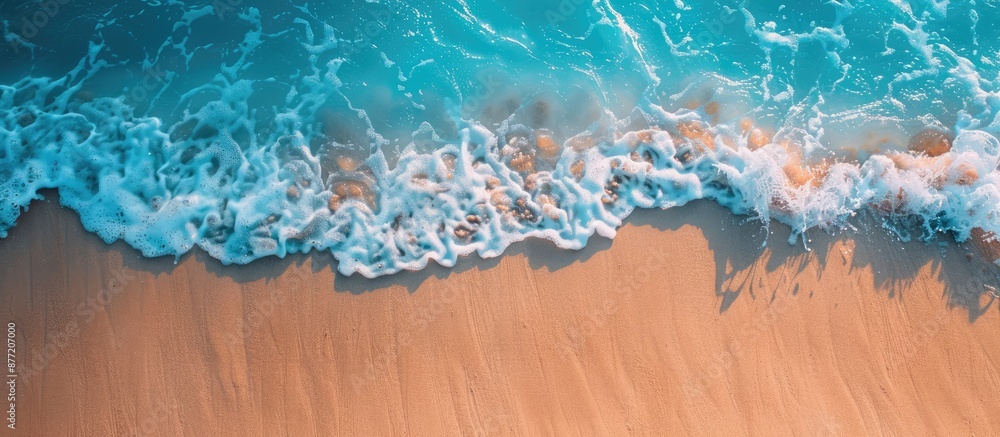 Aufkleber Sunny tropical beach scene with a gentle sea wave rolling on the sand and plenty of copy space for adding text or images in the top down view
