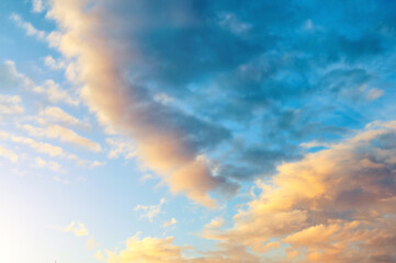 Obraz premium Sunset sky background. Picturesque colorful clouds lit by sunlight