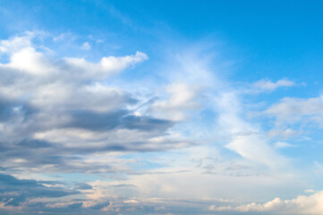 Fototapeta premium Blue sky landscape with dramatic colorful clouds and soft sunlight