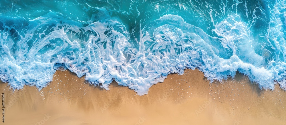 Poster soothing view of a blue ocean wave and sandy beach with copy space image
