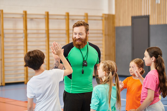 A bearded man stands confidently in front of a group of children, engaging them in a lively classroom setting. - Powered by Adobe