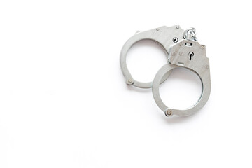 Close up police metal handcuffs, top view. Criminal law and justice concept
