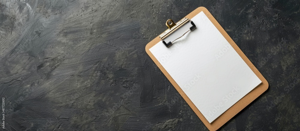Poster Close up of clipboard with blank paper on dark gray background copy space image