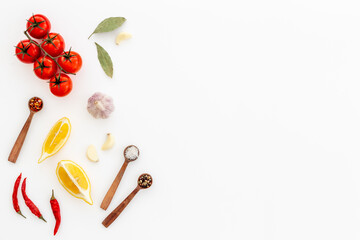 Cooking concept with tomatoes and chili peppers, vegetables spices on the kitchen desk top