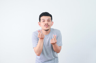 an asian man shows a happy expression and a gesture of love