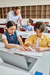 kids are sitting closely together at a table, engrossed in a discussion, their expressions...