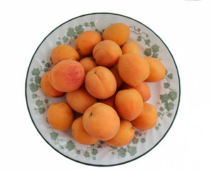 apricots on a plate with white background