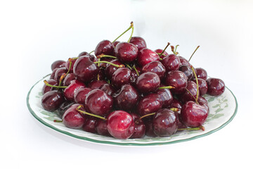 cherries in a bowl with white background