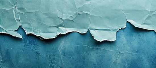 Naklejka premium Vintage blue torn paper texture background with ample copy space image