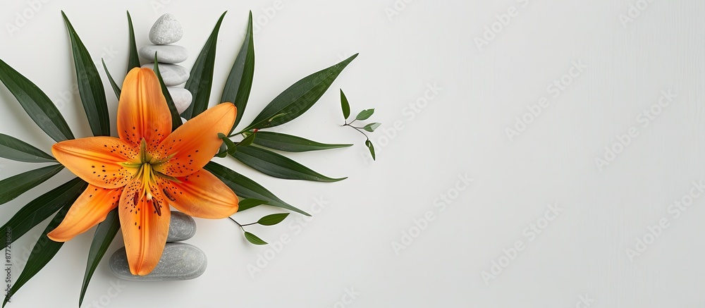 Poster stone balance pyramid an orange lily and green leaves create a soothing spa relaxation concept on a 