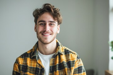 Obraz premium Portrait of a blissful caucasian man in his 20s dressed in a relaxed flannel shirt over minimalist or empty room background