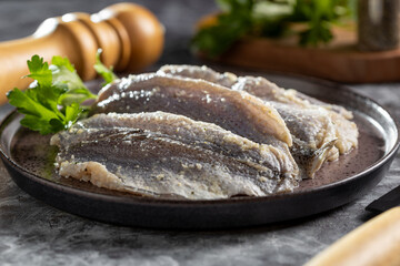 Raw sardine fish seasoned with garlic ready to cook.