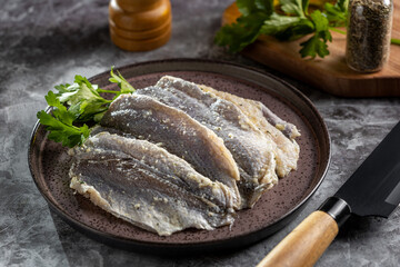 Raw sardine fish seasoned with garlic ready to cook.