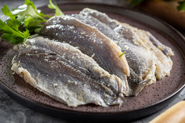 Raw sardine fish seasoned with garlic ready to cook.