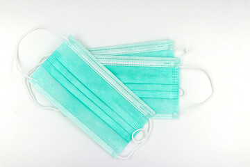 Green medical mask on white background. Prevent the coronavirus.