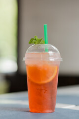 orange cocktail with ice on the table. nonalcoholic drink