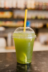 green cocktail with ice on the table. nonalcoholic drink