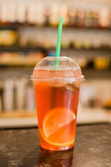 orange cocktail with ice on the table. nonalcoholic drink