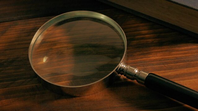 Man Picks Up Magnifying Glass And Puts It Down