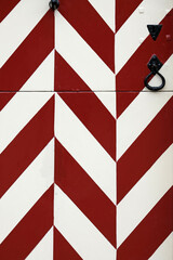 Wooden gate at a castle in the Netherlands with red and white pattern going up and down