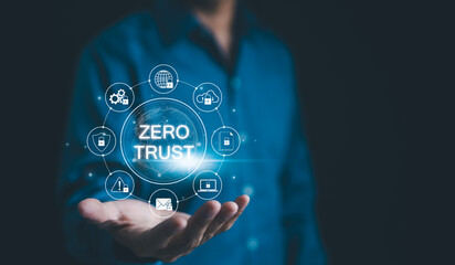 Zero Trust Security Concept. A person holds a holographic representation of "Zero Trust" security model surrounded by various security icons, emphasizing cybersecurity principles. Network access,