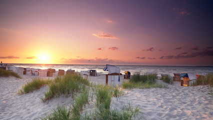 calm sunset on the beach with beach huts