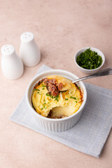 Shepherd's pie in a portioned white baking dish. Homemade traditional casserole (gratin) with minced meat and mashed potatoes. Selective focus, close-up.