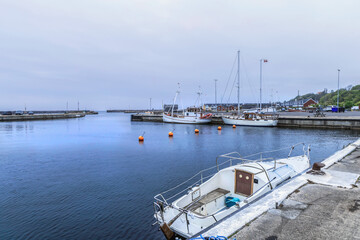 Fototapeta premium Sea pier with boats on a cloudy day. High quality photo