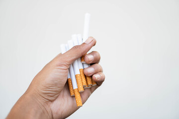 Hand holding multiple cigarettes
