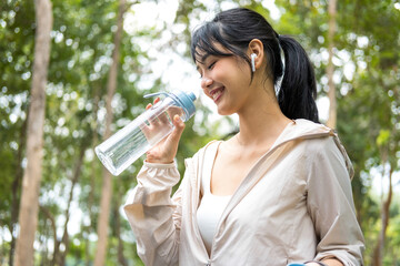 Young woman holding water bottle to drink.