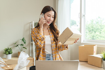 Efficiently preparing packages for seamless shipping. The hands of an online store meticulously...