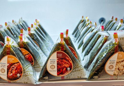 KUANTAN, PAHANG, MALAYSIA - JUNE 21, 2024 : Rows of halal onigiri sold at FamilyMart store. Onigiri consists of rice ball in triangular shape, stuffed with various fillings and wrapped in seaweed.