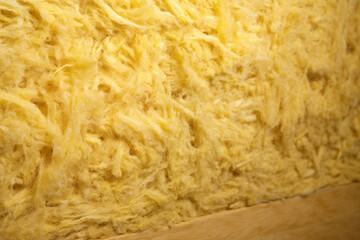 Close up of yellow mineral wool filling used as isolation in wall