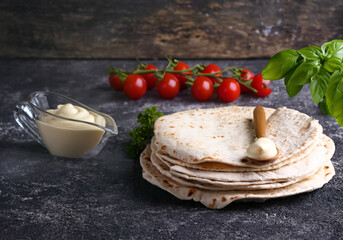 thin pita naan flatbreads with sauce on the table