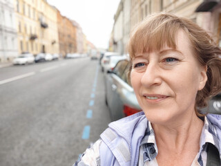 A woman resting while walking on a city street. Female traveler in trip