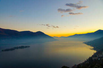 Aerial View over Alpine Lake Maggiore with Fog in twilight with Brissago Islands and Mountain in Brissago, Ticino, Switzerland.