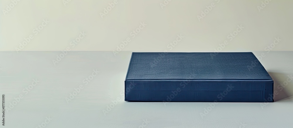 Poster dark blue book placed on a plain white surface with empty copy space image