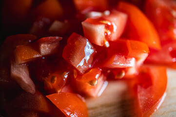 appetizing background of vegetables, sliced ​​red tomatoes and bell peppers on a wooden...