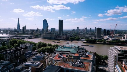 Obraz premium Drone image of the London Skyline featuring clear blue sky with a few clouds